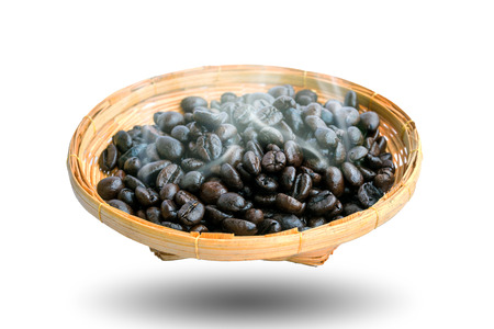 Hot coffee beans in the bamboo plate isolated on white background.の写真素材
