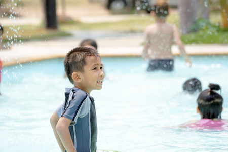 Asian boy in swimwear, swimming fun in the pool.の写真素材
