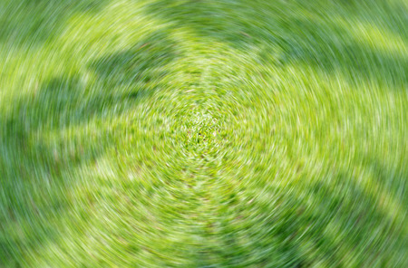 Fresh green comfortable lawn texture background;Radial blur filter effect.