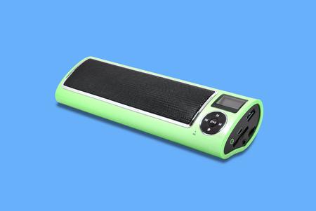 Wireless Bluetooth loudspeaker, mp3 player and radio for computer notebook and smart phone on blue background.の写真素材