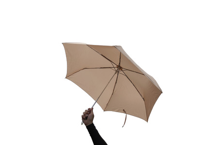 Hand are holding umbrella isolated on white background.の写真素材
