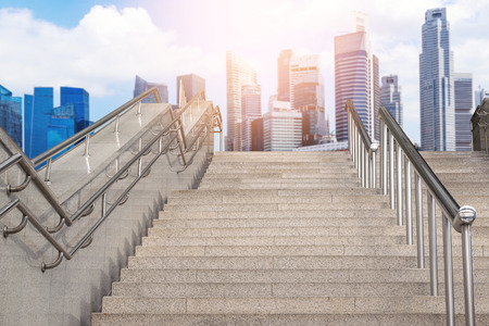 Marble staircase railing stainless steel with the skyscrapers background.の写真素材