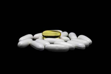 Closeup group of medicines and vitamin tablets on black background.の写真素材