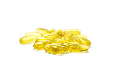 Closeup group of vitamin tablets on white background.の写真素材