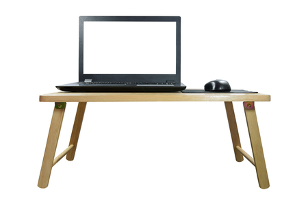 Closeup front view of the laptop and wireless mouse on the wood table isolated on white background.の写真素材