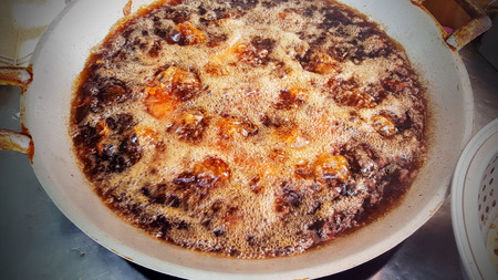 Closeup chicken fried in boiling oil in a pan.の写真素材