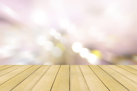 Wooden floor with colorful lighting bokeh background.の写真素材