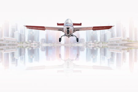 Vintage aircraft flying over the river in the city.
