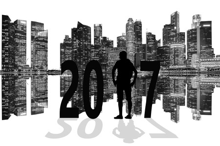 Silhouette of young man standing between 2017 years with beautiful skyscrapers background, black and white tone.の写真素材