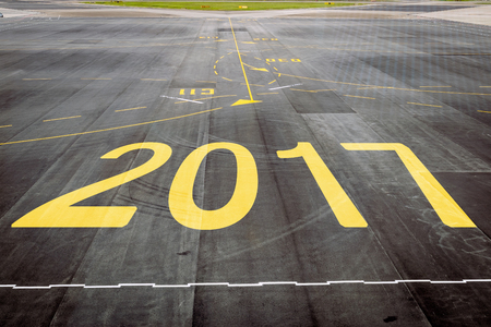 Closeup 2017 figures on the surface of the airport runway texture background.の写真素材