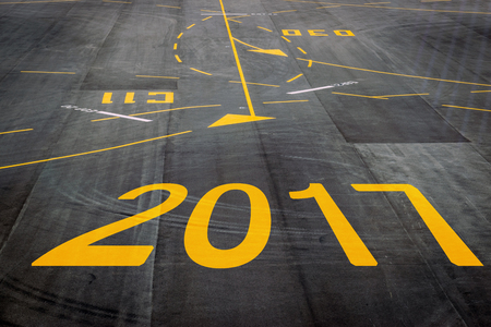 Closeup 2017 figures on the surface of the airport runway texture background.の写真素材