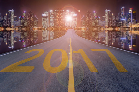 2017 figures on the steet with the skyscraper background for news year.の写真素材