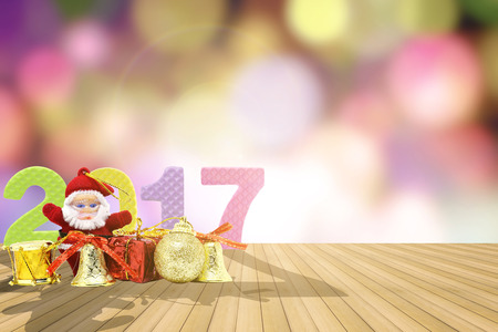 2017 figures and chrismas toy on the wooden floor with bokeh of lighting background for news year.の写真素材