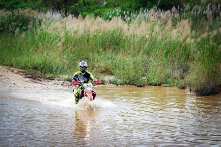 Ratchaburi,Thailand -Dec 4,2016: Motocross is trying to drive across the river to a depth of one meter in the wild.のeditorial素材