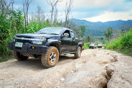 Ratchaburi,Thailand -Dec 4,2016: Four-wheel drive vehicles were trying to go up the mountain road, which is rugged and steep.のeditorial素材