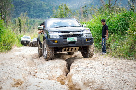 Ratchaburi,Thailand -Dec 4,2016: Four-wheel drive vehicles were trying to go up the mountain road, which is rugged and steep.のeditorial素材