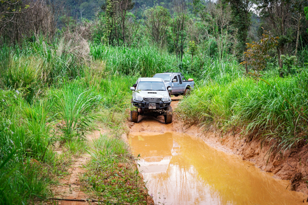 Ratchaburi,Thailand -Dec 4,2016: Four-wheel drive pickup truck were wading across the river in the forest.のeditorial素材