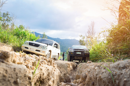 Ratchaburi,Thailand -Dec 4,2016: Four-wheel drive vehicles were trying to go up the mountain road, which is rugged and steep.のeditorial素材