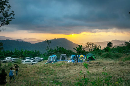 Ratchaburi,Thailand -Dec 4,2016: Visitors drive up tent camping on the highest point of the mountain to watch the beautiful sunset.のeditorial素材