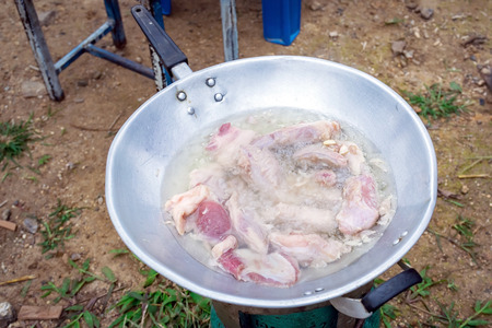 Fried pork in a frying pan with gas stove picnic.の写真素材