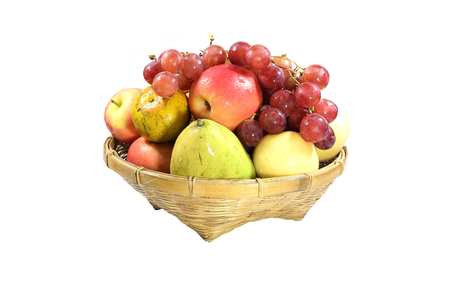 Fruits of other species in a bamboo basket isolated on white background.の写真素材