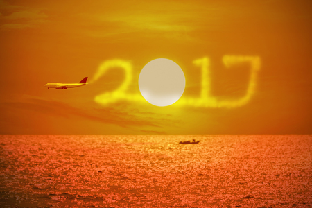 2017 figures news year drawing by airplane in the sky over the sea and beautiful sunset.
