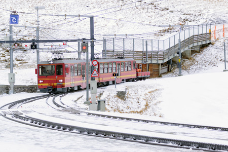 Jungfrau,Switzerland-Jan 4,2017: Scenic railway to Klein's Scheidegg mountain pass, a famous ski resort area, to admire the passing scenic valleys and the Glacier Falls.のeditorial素材