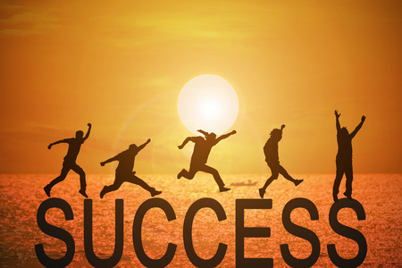 Silhouette group of young mans jumping over the success words  with beautiful sunset at the sea background, concept for success and victory in business.の写真素材
