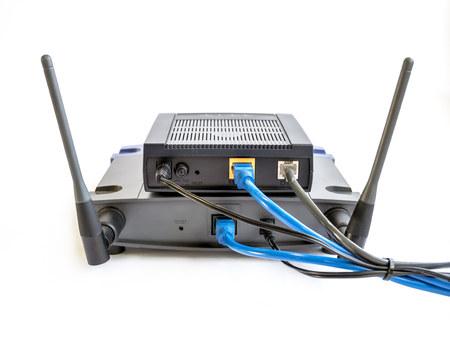Internet router and wireless access point with cable isolated on white background.の写真素材