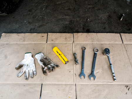 Closeup wrench and work gloves mechanic put on paper.の写真素材