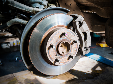 Closeup disc brake of the vehicle for repair.の写真素材
