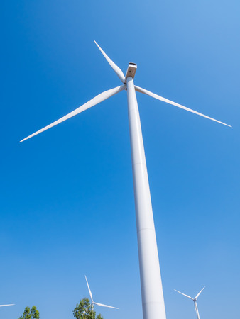 Wind turbine for electricity production on the mountains and beautiful sky.の写真素材