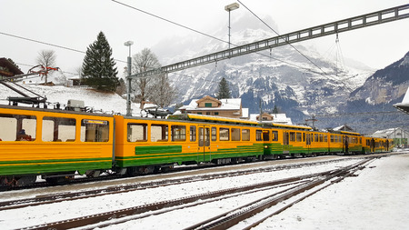 Scenic railway to Kleine Scheidegg mountain pass, a famous ski resort area, to admire the passing scenic valleys and the Glacier Falls in Switzerland.の写真素材