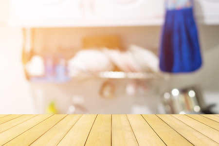 Top of the wood table on blur kitchen room background-can use for display or put your products and some food.の写真素材