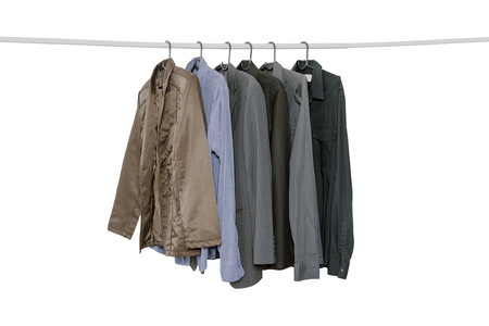 Collection of men's long sleeve shirts hanging on the clothes line isolated on white background with clipping path, lifestyle, beauty and fashion concept.の写真素材