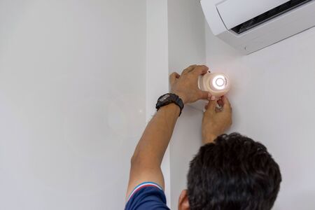 Technicians are installing a CCTV camera on the wall, can connect to the Internet, and control the...