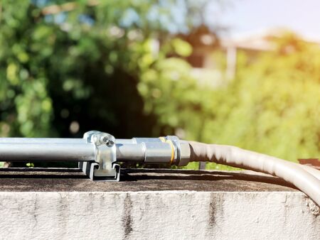 Closeup the steel pipes for external electrical wires installed on the wall.の写真素材