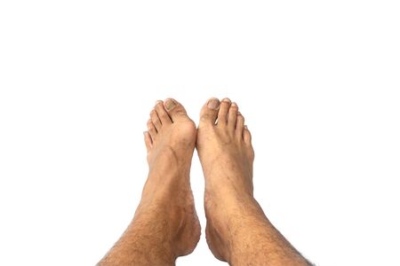 Closeup men's feet isolated on white background.の写真素材