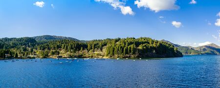 Panorama picture of beautiful lake and mountains under the blue sky in Japan on the winter season.の写真素材