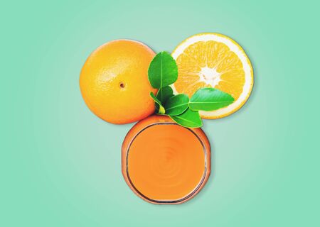 Top view of the orange juice and oranges isolated on pastel color background, with  .の写真素材