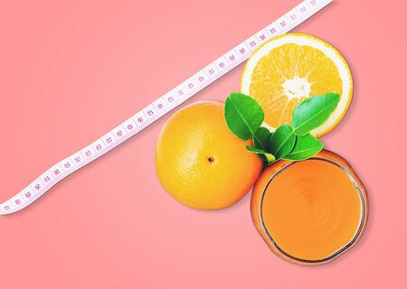 Top view of the orange juice and oranges with the measuring tape  isolated on pastel color background, with  .の写真素材
