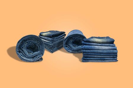 Rows and stacks of of blue jeans long legs for men and  isolated on pastel color background with  .の写真素材