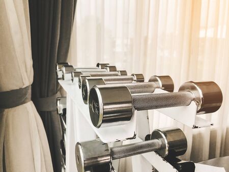 Closeup group of dumbbells different weights for exercising arm muscles in the gym.の写真素材