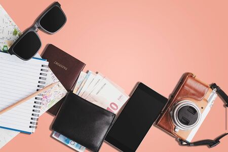 Top view of a group of essential equipment for traveling on pastel color background, with clipping path.の写真素材