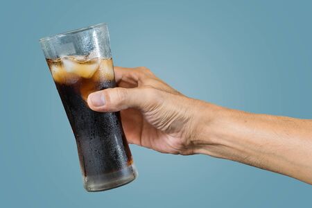 of a  holding a  glass with ices isolated on pastel color background,with  -Food and drink industry and celebrations concepts.の写真素材