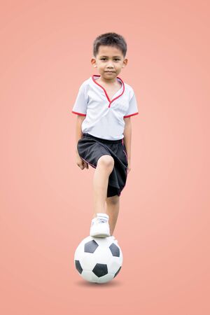 The  in sportswear wearing sneakers is stepping on a soccer ball isolated on pastel color background, with  .の写真素材