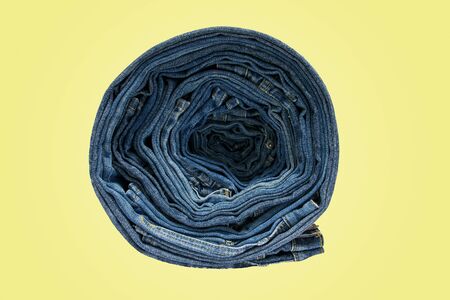 Row of blue jeans long legs for men and women isolated on pastel color backgroundの写真素材