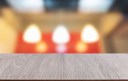 Tabletop made of wood with the blurred background of lighting bokeh, used for placing your products and objects.の写真素材