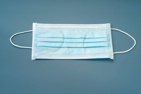 Sanitary napkin mask for preventing spreading and respiratory infections isolated on blue pastel background, Stop Coronavirus Covid-19 concept.の写真素材