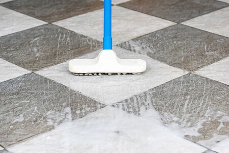 Cleaning the tile floor with floor scrubber brush.の写真素材